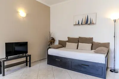 a bedroom with a bed and a tv in a room at #344 Edificio Marina Sol by Home Holidays in Branqueira