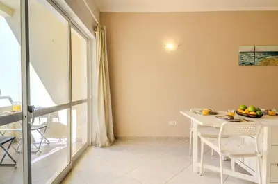 a dining room with a table and a window at #344 Edificio Marina Sol by Home Holidays in Branqueira