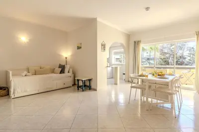 a living room with a bed and a table at #344 Edificio Marina Sol by Home Holidays in Branqueira