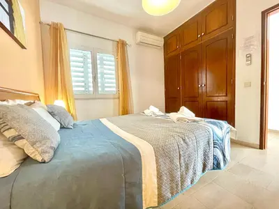 a bedroom with a large bed in a room at Villa Jose in Olhos de Água