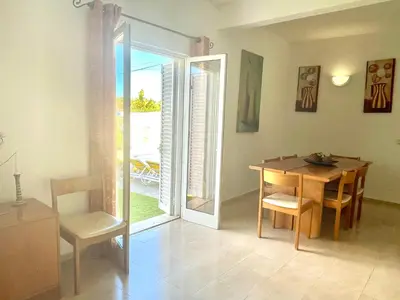 a dining room with a table and a table and chairs at Villa Jose in Olhos de Água