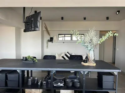 a living room with a table with a vase of flowers at Blue Coast Penthouse T4 in Quarteira