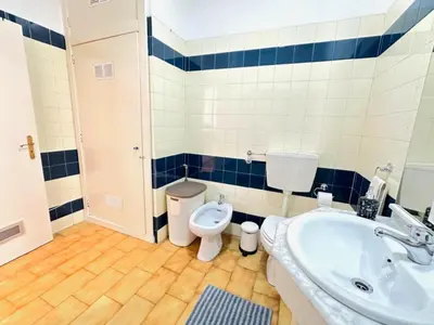 a bathroom with a sink and a toilet at Apartamento Gaivotas in Albufeira