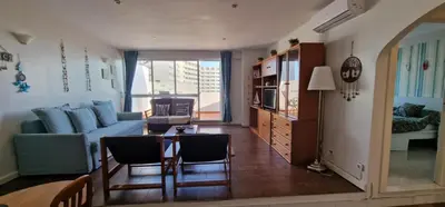 a living room with a couch and a table at Apartamento Gaivotas in Albufeira
