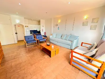 a living room with a couch and a table at Apartamento Gaivotas in Albufeira