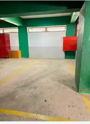 an empty parking garage with red and green walls at Apartamento Gaivotas in Albufeira