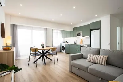 a living room with a couch and a table at LIA - Quarteira in Quarteira