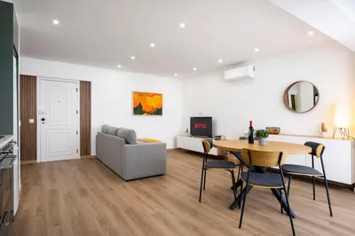 a living room with a table and a couch at LIA - Quarteira in Quarteira