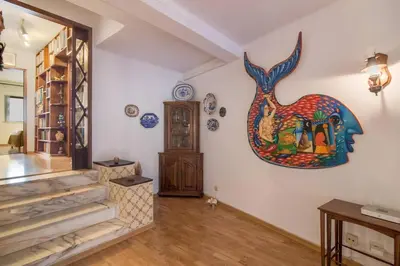 a room with a painting of a giraffe on the wall at Albufeira INN - Av Liberdade T2 in Albufeira