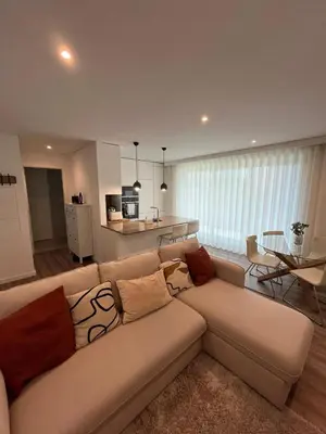 a living room with a couch and a table at NEW Apartment, Sea Front & Pool in Quarteira