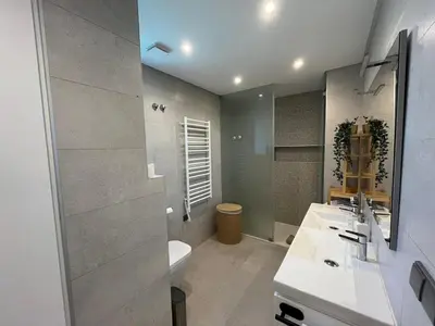 a bathroom with a sink and a toilet and a mirror at NEW Apartment, Sea Front & Pool in Quarteira