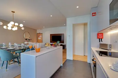 a kitchen and living room with a dining room at New Beach Apartment in Quarteira