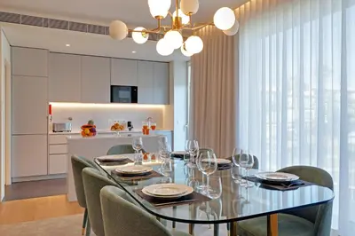 a dining room with a glass table and chairs at New Beach Apartment in Quarteira