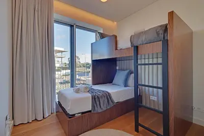 a bedroom with a bunk bed with a large window at New Beach Apartment in Quarteira