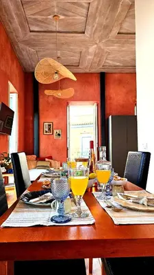 a dining room table with wine glasses on it at Espaço Luzitano, fabulous and stylish spot, Faro city center, Wi-fi in Faro