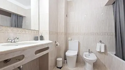 a white bathroom with a sink and a toilet at JC HOUSE - T0 - Smart Stay Albufeira - BY BEDZY in Albufeira
