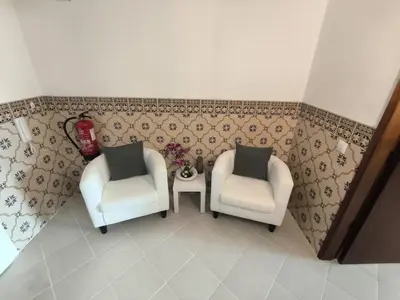 two chairs and a table in a room at JC HOUSE - T0 - Smart Stay Albufeira - BY BEDZY in Albufeira