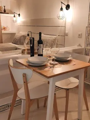 a dining room table with a bottle of wine and glasses at JC HOUSE - T0 - Smart Stay Albufeira - BY BEDZY in Albufeira