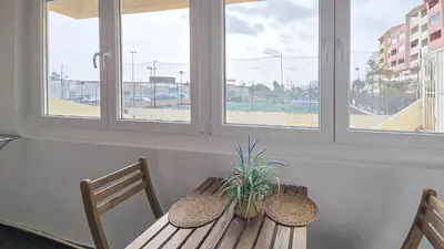 a wooden table with two chairs and a plant on it at JC HOUSE - T0 - Smart Stay Albufeira - BY BEDZY in Albufeira