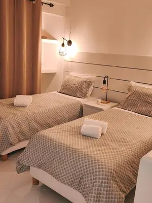 a bedroom with two beds with white sheets at JC HOUSE - T0 - Smart Stay Albufeira - BY BEDZY in Albufeira