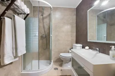 a bathroom with a toilet sink and a washing machine at T1 Sol e Mar in Albufeira