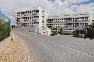 a large room with a bed and a kitchen at T1 Sol e Mar in Albufeira