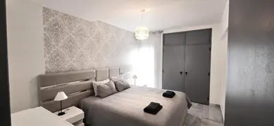 a bedroom with a bed with a black bag on it at Ocean View in Albufeira