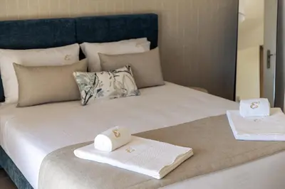 a bed with two towels sitting on top of it at Villa e5 in Tunes