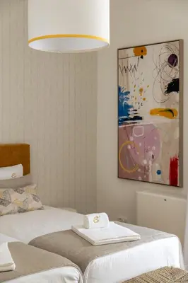 a bedroom with a bed and a painting on the wall at Villa e5 in Tunes