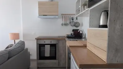 a kitchen with a stove and a couch in a room at Albufeira Spring, Summer & Fall in Albufeira