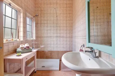 a bathroom with a sink and a toilet and a mirror at Quinta do Mocho in Alcaria
