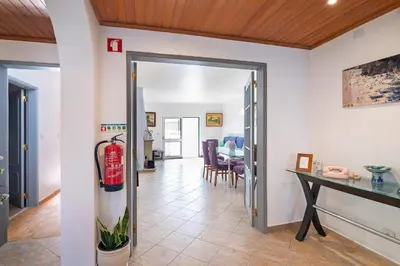 a living room with a fire hydrant in the doorway at Habemus Domu Albufeira in Albufeira