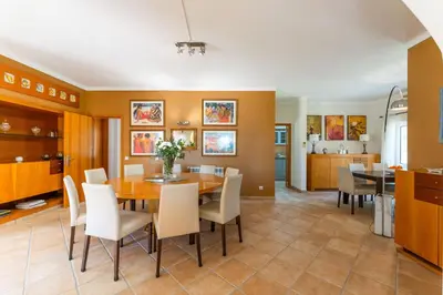a kitchen and dining room with a table and chairs at Monte Da Poupa - 7 bedroom villa - Sleeps 15 in Albufeira