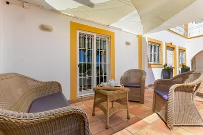 a patio with wicker chairs and a table at Monte Da Poupa - 7 bedroom villa - Sleeps 15 in Albufeira