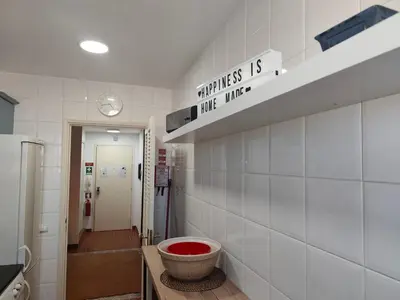 a bathroom with a ladder next to a toilet and a sink at Excelente apartamento em Albufeira in Albufeira