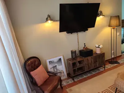 a bedroom with a bed and a lamp and a dresser at Excelente apartamento em Albufeira in Albufeira