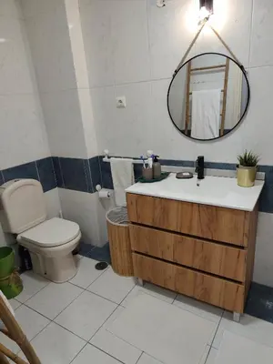 a bathroom with a sink and a mirror and a rug at Excelente apartamento em Albufeira in Albufeira
