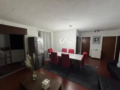 a bedroom with a bed and a flat screen tv at Casa Lopes in Albufeira