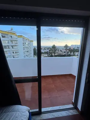 a bedroom with a bed and a chair at Casa Lopes in Albufeira