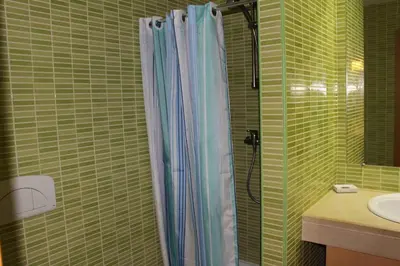 a bathroom with a shower curtain and a sink at Spacious apartment in Albufeira 200 m² with shared pool in Albufeira