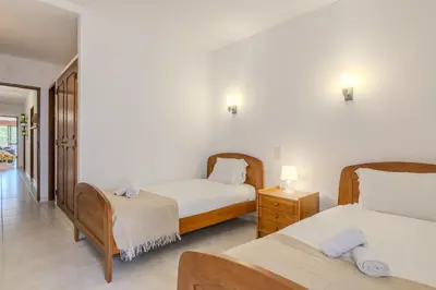 a bedroom with two beds and a night stand with lamps at #351 Edificio Marina 1 D by Home Holidays in Páteo