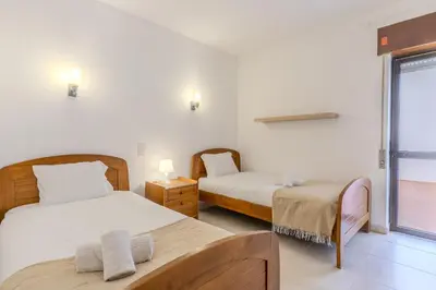 a bedroom with two beds and a window at #351 Edificio Marina 1 D by Home Holidays in Páteo