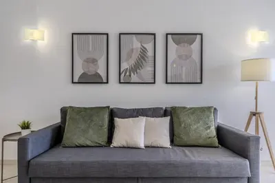 a living room with a couch and four pictures on the wall at #351 Edificio Marina 1 D by Home Holidays in Páteo
