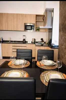 a kitchen with two tables with wine glasses on them at Casa luz e conforto-Casa 20 in Almancil