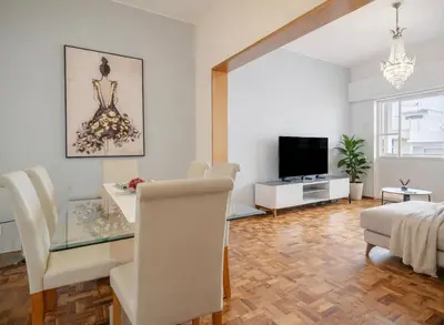 a living room with a dining table and a television at Dream House in Loulé
