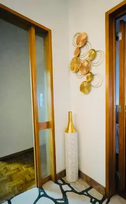 a room with a wall with gold decorations on the wall at Dream House in Loulé