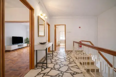 a living room with a staircase and a television at Dream House in Loulé