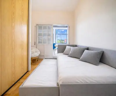 a large couch in a room with a window at Dream House in Loulé