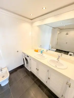 a bedroom with a bed with red flowers on it at Windmill Hill Apartment in Albufeira