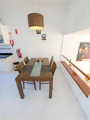 a small kitchen with a wooden table and chairs at Windmill Hill Apartment in Albufeira